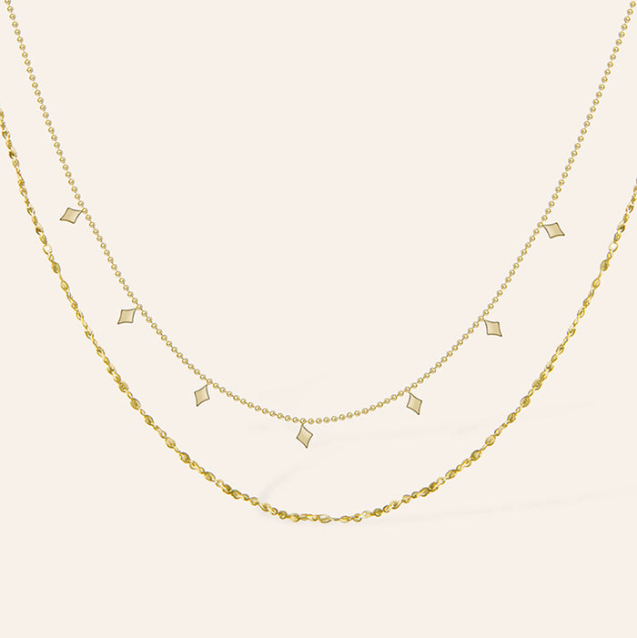 Dubbele gouden ketting met ruitvormige hangers – Agatha van Amberz.