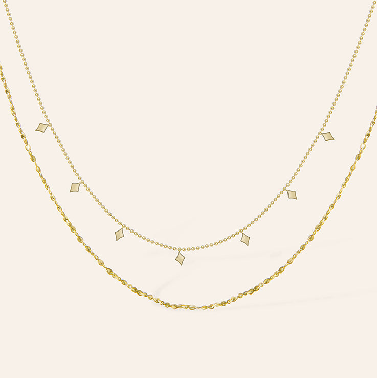Dubbele gouden ketting met ruitvormige hangers – Agatha van Amberz.