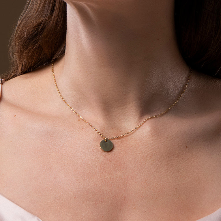 Gouden ketting met ronde munt hanger – Sandra van Amberz.